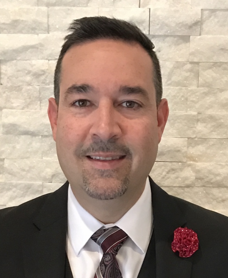Professional headshot of David De La Noval